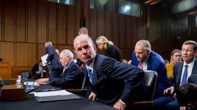 Boeing President and CEO Dennis Muilenburg leaves after testifying on Capitol Hill, Oct. 29, 2019.