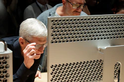 In this June 3, 2019, file photo, Apple CEO Tim Cook, left, and chief design officer Jonathan Ive look at a Mac Pro in San Jose, Calif.