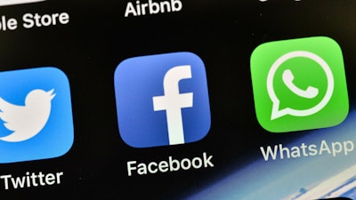 In this Nov. 15, 2018, file photo, the icons of Facebook and WhatsApp pictured on an iPhone in Gelsenkirchen, Germany.