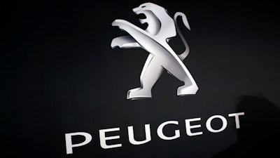 In this March 1, 2018 photo, the logo of Peugeot is displayed at PSA Peugeot Citroen headquarters during the presentation of the company's 2017 full year results, in Rueil-Malmaison, west of Paris, France. Italian-American carmaker Fiat Chrysler Automobiles on Wednesday, Oct. 30, 2019 confirmed that it is in talks with French rival PSA Peugeot, its second bid this year to reshape the global auto industry facing huge challenges with the transition to electric and autonomous vehicles.