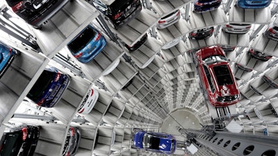 In this March 14, 2017, file photo, Volkswagen cars are lifted inside a delivery tower in Wolfsburg, Germany.