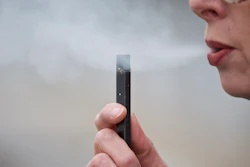 In this April 16, 2019, file photo, a woman exhales a puff of vapor from a Juul pen in Vancouver, Wash.