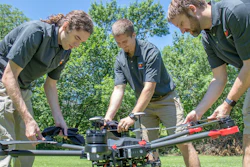 Evan Beachly (from left), Jim Higgins and Carrick Detweiler assemble a drone system before taking it for a test flight.