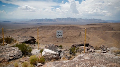 In this July 14, 2018, file photo, a sign warns of a falling danger on the crest of Yucca Mountain.