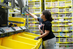 In this June 26, 2019, file photo a worker sorts through items and places orders at the Amazon Fulfillment Center in Staten Island in New York. Amazon.com Inc. reports financial earns on Thursday, Oct. 24.