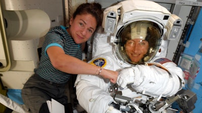 In this image released Friday, Oct. 4, 2019, by NASA, astronauts Christina Koch, right, and, Jessica Meir pose on the International Space Station. The first all-female spacewalk is back on, six months after a flap over spacesuits led to an embarrassing cancellation. NASA announced Friday that the two U.S. astronauts aboard the International Space Station will pair up for a spacewalk later this month.