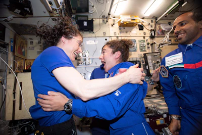 In this photo made available by NASA astronaut Jessica Meir on Sept. 29, 2019, Christina H. Koch, left, and Meir greet each other after Meir's arrival on the International Space Station. On Friday, Sept. 4, 2019, NASA announced that the International Space Station’s two women will pair up for a spacewalk on Oct. 21 to plug in new batteries.
