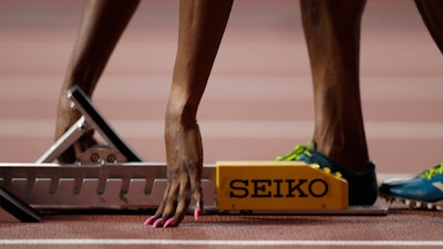 Patience Okon George, of Nigeria adjusts her starting blocks before a women's 400 meter heat at the World Athletics Championships in Doha, Qatar, Monday, Sept. 30, 2019.