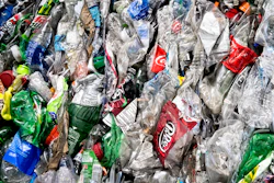 In this Nov. 15, 2016, file photo, crushed plastic bottles sit in a bale following sorting at the Mid-America Recycling plant, in Lincoln, Neb. Coca-Cola Co., PepsiCo and Keurig Dr. Pepper are investing $100 million to improve U.S. bottle recycling and processing.
