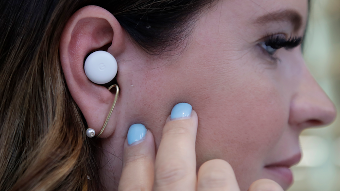In this Tuesday, Sept. 24, 2019, photo Isabelle Olsson, head of color & design for Nest, shows Pixel buds in her ear at Google in Mountain View, Calif.