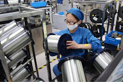 In this Aug. 14, 2019, file photo, a woman works on a production line in a fiber optics factory in Nantong in eastern China's Jiangsu province. China's factory activity shrank more sharply than expected in October amid weak consumer demand and a tariff war with Washington, a survey by an industry group showed Thursday, Oct. 31, 2019.