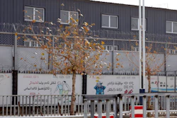In this Dec. 5, 2018, file photo, two layers of barbed wire fencing ring the 'Hotan City apparel employment training base' where Hetian Taida Apparel Co. has a factory in Hotan in western China's Xinjiang region. The Trump Administration is blocking shipments from Chinese company Hetian Taida Apparel, which makes baby pajamas sold at Costco warehouses, after the foreign manufacturer was accused of forcing ethnic minorities locked in an internment camp to sew clothes against their will.