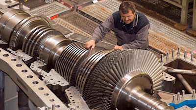 In this Oct. 14, 2009 file photo an employee of MAN Turbo company works on compressors and turbines at the factory in Oberhausen, western Germany. A German machine engineering association says that orders for German machinery, an important export, plummeted in August adding to signs of a recession in Europe’s biggest economy.