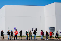 General Motors' Flint Assembly Plant employees line the street with picket signs during the nationwide UAW strike against General Motors on Monday, Oct. 7, 2019, in Flint, Mich.
