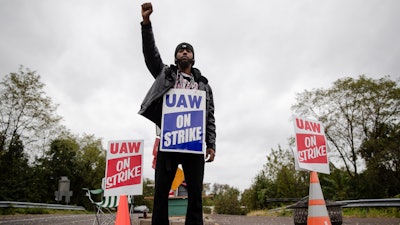 Ryan Piper with the United Auto Workers continues to picket after news of a tentative contract agreement with General Motors, in Langhorne, Pa., Wednesday, Oct. 16, 2019. Bargainers for General Motors and the United Auto Workers reached a tentative contract deal on Wednesday that could end a monthlong strike that brought the company's U.S. factories to a standstill.