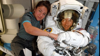 In this image released Friday, Oct. 4, 2019, by NASA, astronauts Christina Koch, right, and, Jessica Meir pose for a photo on the International Space Station. NASA has moved up the first all-female spacewalk to Thursday, Oct. 17, 2019, or Friday because of a power system failure at the International Space Station.