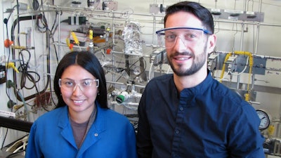 Aisulu Aitbekova, left, and Matteo Cargnello in front of the reactor where Aitbekova performed much of the experiments for this project.