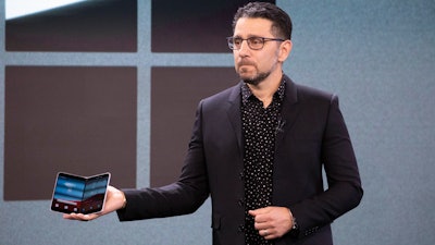 Microsoft's Chief Product Officer Panos Panay holds a Surface Duo at an event, Wednesday, Oct. 2, 2019 in New York.