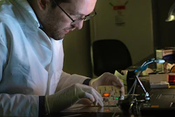 Rice University graduate student Thomas Heiderscheit demonstrates a technique to amplify the light from small concentrations of molecules on a surface by maximizing the spectral overlap between the emission and the plasmon resonance of adjacent nanoparticles. The glowing molecules can be clearly seen in the sample when excited.