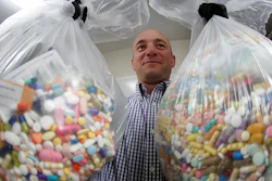 In this Wednesday, Sept. 11, 2019, file photo, narcotics detective Ben Hill, with the Barberton Police Department, shows two bags of medications that are are stored in their headquarters and slated for destruction in Barberton, Ohio. Jury selection is set to begin Wednesday, Oct. 16, 2019, in the first federal trial over the nation's opioid epidemic.
