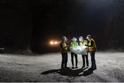 Berk Tulu, assistant professor of mining engineering, studies a map with personnel from Laurel Aggregates, a large surface and underground limestone quarry near Morgantown. (Left to Right) Barry Fink, Tulu, Brian Cramer, Richard Rohrssen.
