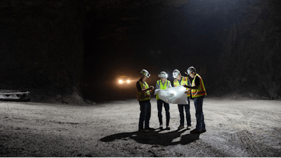 Berk Tulu, assistant professor of mining engineering, studies a map with personnel from Laurel Aggregates, a large surface and underground limestone quarry near Morgantown. (Left to Right) Barry Fink, Tulu, Brian Cramer, Richard Rohrssen.