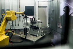 In this May 18, 2017, file photo, a robotic arm with a high-intensity blowtorch is remotely operated to test ceramic matrix composites, which make engines more durable, heat-resistant and efficient, at the General Electric Aviation plant in Evendale, Ohio. General Electric Co. said Monday, Oct. 7, 2019, that it will freeze its pension plan for about 20,700 salaried workers as part of its debt-cutting plan.