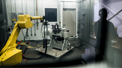 In this May 18, 2017, file photo, a robotic arm with a high-intensity blowtorch is remotely operated to test ceramic matrix composites, which make engines more durable, heat-resistant and efficient, at the General Electric Aviation plant in Evendale, Ohio. General Electric Co. said Monday, Oct. 7, 2019, that it will freeze its pension plan for about 20,700 salaried workers as part of its debt-cutting plan.