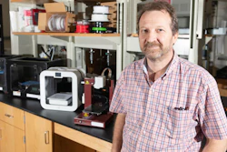 Rodney Weber, a professor in Georgia Tech's School of Earth & Atmospheric Sciences, stands in his lab alongside several consumer-grade 3D printers.