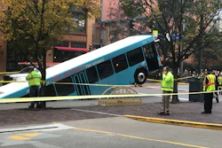 Authorities investigate after a Port Authority bus was caught in a sinkhole in downtown Pittsburgh on Monday, Oct. 28, 2019. The Port Authority of Allegheny County says the lone passenger is being treated Monday morning for minor injuries.