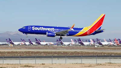 In this March 23, 2019 file photo a Southwest Airlines Boeing 737 Max aircraft lands at the Southern California Logistics Airport in the high desert town of Victorville, Calif. Southwest said Thursday, Oct. 17, that it will keep its Boeing 737 Max jets out of its schedule until Feb. 8, about a month longer than previously planned.