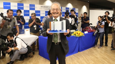 Winner of Nobel Prize of Chemistry Akira Yoshino poses a photo with a model Lithium-ion battery during a press conference in Tokyo, Wednesday, Oct. 9, 2019. Yoshino is one of the three scientists who have won this year's Nobel Prize in Chemistry for their contributions to lithium-ion batteries, which have reshaped energy storage and transformed cars, mobile phones and many other devices in an increasingly portable and electronic world.