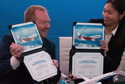 Boeing Commercial Airplanes president and CEO Stanley A. Deal, left, and Air Astana chief planning officer Alma Aliguzhinova pose at a news conference at the Dubai Airshow, Nov. 19, 2019.