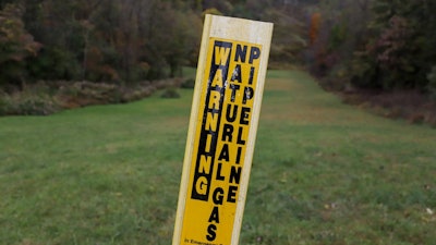 In this Oct. 17, 2019, photo, a post marks the location of a shale gas pipeline in Zelienople, Pa.