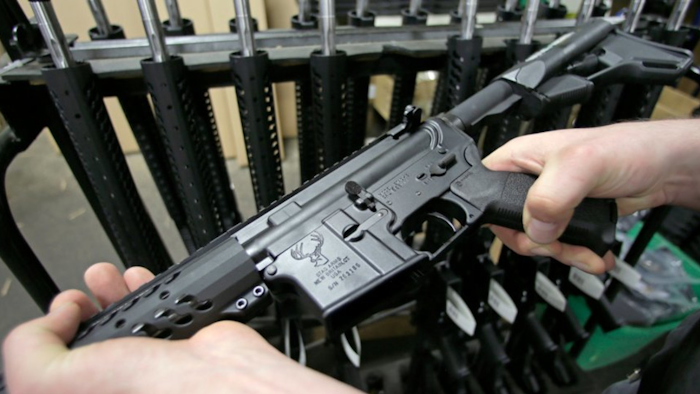 Craftsman Veetek Witkowski holds a newly assembled AR-15 rifle at the Stag Arms company in New Britain, Conn., April 10, 2013.