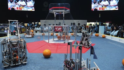 In this Oct. 25, 2019, file photo, a team from Korea, on the right, competes with UAE Falcons during the First Global Challenge, a robotics and artificial intelligence competition in Dubai, United Arab Emirates.