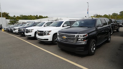 In this Sept. 30, 2019, photo, a row of Chevrolet Suburban vehicles are shown at Wally Edgar Chevrolet in Orion Township, Mich.