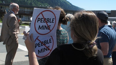 This June 25, 2019, photo shows people gathered outside U.S. Sen. Lisa Murkowski's office in Juneau, Alaska, to protest the proposed Pebble Mine.