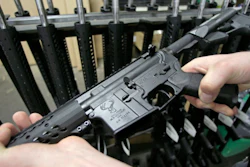 Craftsman Veetek Witkowski holds a newly assembled AR-15 rifle at the Stag Arms company in New Britain, Conn., April 10, 2013.