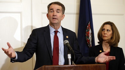 Virginia Gov. Ralph Northam, accompanied by his wife, Pam, speaks during a news conference in the governor's mansion in Richmond, Feb. 2, 2019.