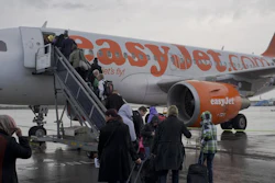 In this Oct. 18, 2012, file photo, passengers board a London-bound EasyJet flight at Amsterdam's Schiphol airport, Netherlands.