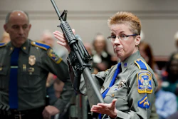 In this Jan. 28, 2013, file photo, Det. Barbara J. Mattson of the Connecticut State Police holds up a Bushmaster AR-15 rifle.