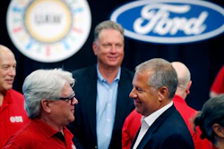 In this July 15, 2019, file photo, United Auto Workers Local 600 President Bernie Ricke, left, talks with Ford Motor Co. President-Automotive Joseph Hinrichs after opening contract talks in Dearborn, Mich.