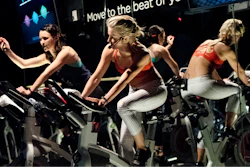 In this March 1, 2017, file photo, Jamey Powell, left, and Julianne Hough lead an exercise class as the participants are introduced to the Alta HR fitness tracker at Swerve cycling center in New York. Google’s parent company is buying wearable device maker Fitbit for about $2.1 billion. Alphabet said Friday, Nov. 1, 2019, that it will pay $7.35 per share.