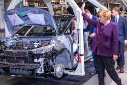 German Chancellor Angela Merkel waves to workers on the production line for ID.3 in Zwickau, Nov. 4, 2019.