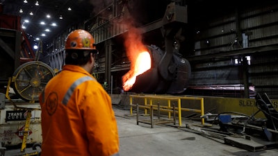 In this June 28, 2018, file photo, senior melt operator Randy Feltmeyer watches a giant ladle after pouring red-hot iron at the U.S. Steel Granite City Works in Granite City, Ill.