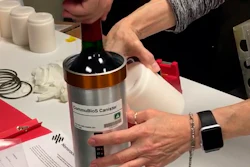 In this Saturday, Nov. 2, 2019 photo provided by Space Cargo Unlimited, researchers with Space Cargo Unlimited prepare bottles of French red wine to be flown aboard a Northrop Grumman capsule from Wallops Island, Va., to the International Space Station. The wine will age for a year up there before returning to the Luxembourg company. Company officials say researchers will study how weightlessness and space radiation affect the aging process.