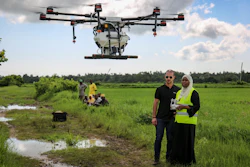 Eduardo Rodriguez, left, of drone manufacturer DJI, trains Khadija Ali Abdulla, right, from the State University of Zanzibar how to fly a drone at Cheju paddy farms, Oct. 31, 2019.