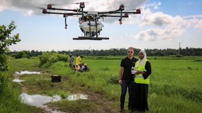 Eduardo Rodriguez, left, of drone manufacturer DJI, trains Khadija Ali Abdulla, right, from the State University of Zanzibar how to fly a drone at Cheju paddy farms, Oct. 31, 2019.