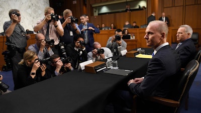 In this Oct. 29, 2019, file photo, Boeing President and CEO Dennis Muilenburg, second from right, and Boeing Commercial Airplanes Vice President and Chief Engineer John Hamilton, right, on Capitol Hill.